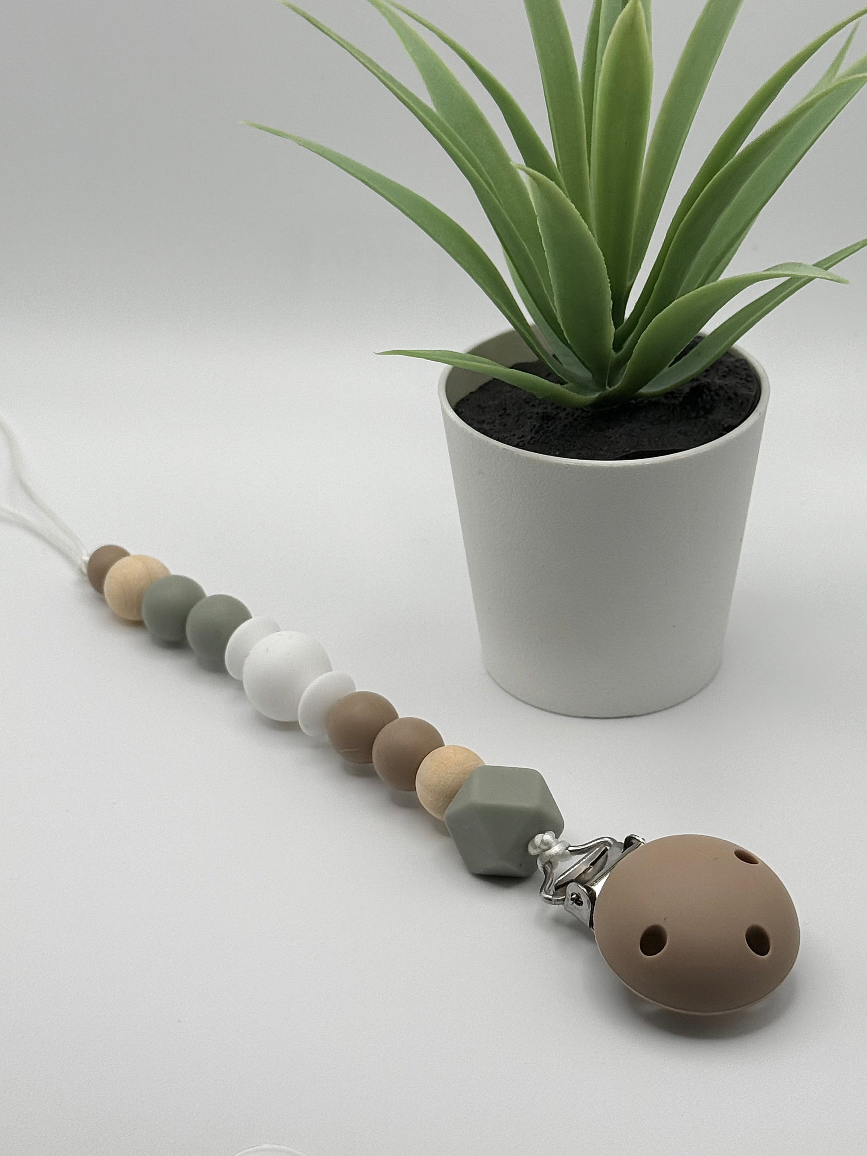 Attache-suce en silicone alimentaire, sécuritaire et durable. Confection québécoise. Parfait pour garder la suce propre et accessible.